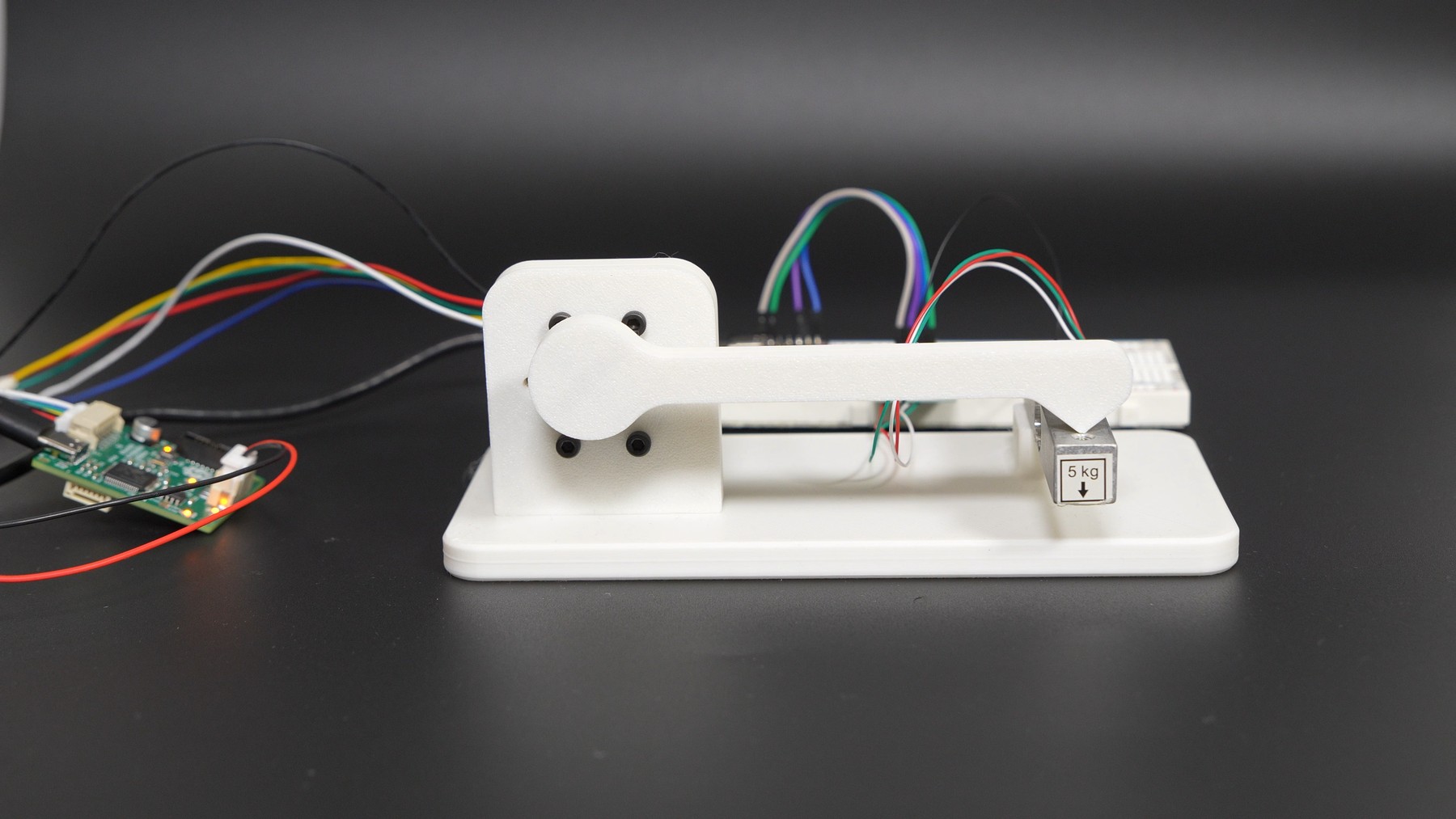 The torque test rig: a lever arm on the motor shaft pressing on a load cell