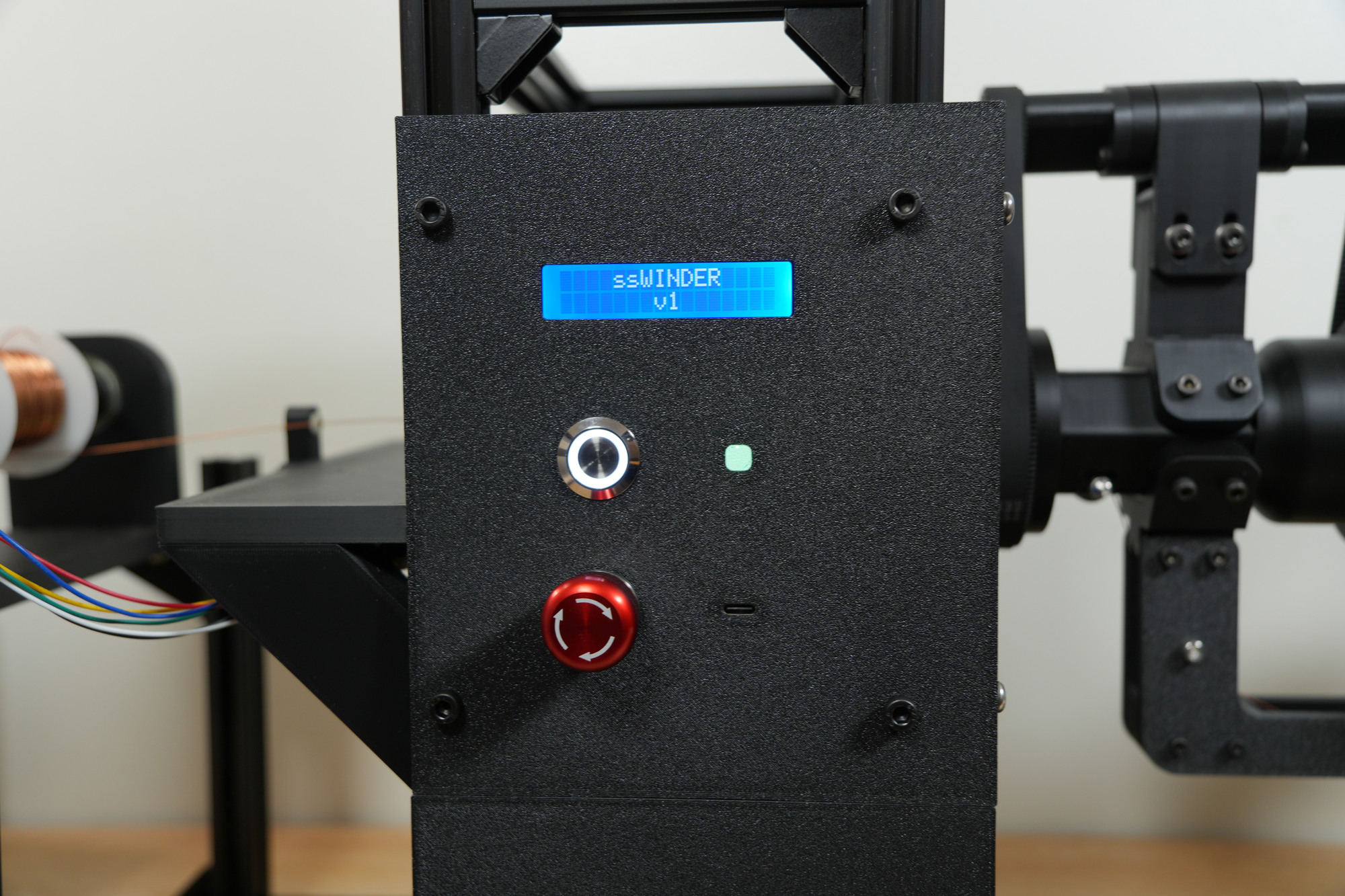 The front panel, with a status screen, a push button and an emergency stop